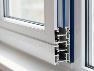Cross-section of a multi-chambered UPVC window profile, showing insulation layers, bright indirect daylight, crisp architectural detail.