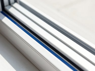 Close-up macro shot of a clean UPVC sliding window track with double rollers, bright daylight, sharp focus, geometric lines.