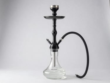 An elegant modern hookah with a sleek black metal stem and clear glass base in a bright studio setting