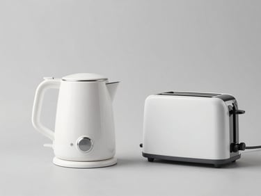 Modern electric kettle and minimalist toaster on a clean gray studio background, high-key lighting