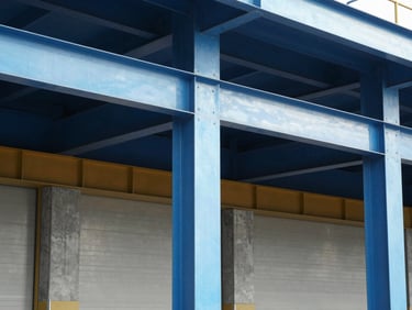 Close-up of industrial architectural details, structural steel columns and concrete loading dock, sharp focus, bright natural light