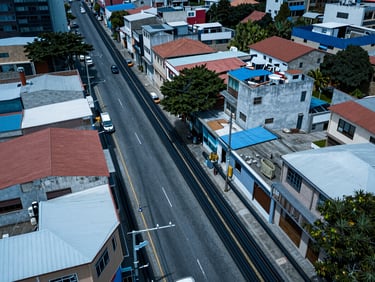 Aerial shot of Valparaíso Colombia municipality streetscape with fiber conduit infrastructure, cool blue daylight, technical overhead framing