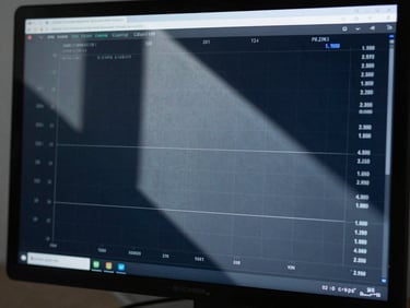 Sharp close-up of real-time performance metrics on a dark monitor, cool blue daylight casting sharp geometric shadows.