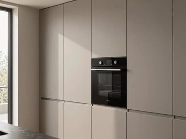 Architectural shot of a modern kitchen wall, high-end oven perfectly flush-integrated into tall warm gray lacquer cabinets, clean vertical lines.
