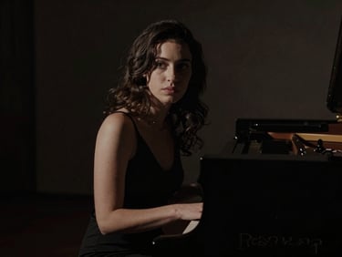 Moody portrait of Eliana at a grand piano, low light, deep shadows, cinematic anamorphic crop, 35mm anamorphic lens.
