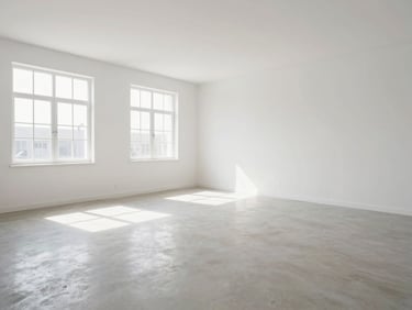 A clean, empty room after an estate cleanout, bright natural daylight, wide-angle lens, high-contrast tones.