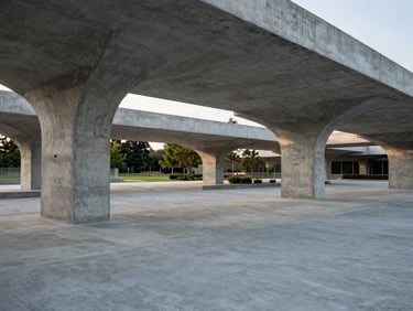 Wide environmental shot of a completed concrete corporate park structure.