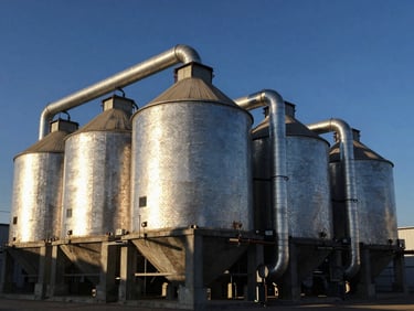 Industrial brick and concrete furnace structure for grain drying, metallic pipes, high-contrast daylight, sharp focus