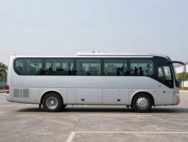 Side view of a modern mid-size silver charter bus parked on a clean asphalt lot, bright natural daylight, sharp focus, 35mm lens