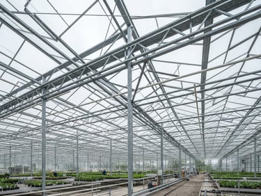 Low-angle architectural shot of a massive commercial glass greenhouse structure under bright overcast daylight, showcasing heavy-gauge galvanized steel trusses and precise engineering lines.