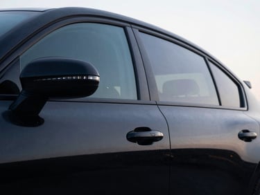 Low-angle heroic car portrait, side windows with a medium dark tint, sharp LED reflections, deep glossy paint, dark low-key automotive photography, 50mm