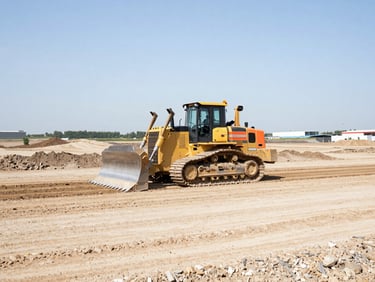 A high-contrast wide-angle shot of a bulldozer grading a massive commercial site under bright daylight, safety orange accents visible