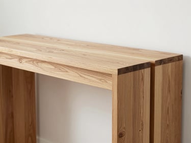 A custom-made wooden console table with intricate joinery, showcasing precise craftsmanship and grain matching, bright studio light.
