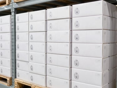 Bright industrial photography of neatly stacked shipping boxes of small consumer accessories on steel warehouse shelving