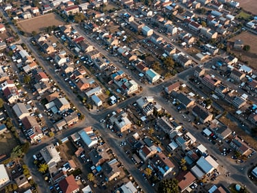 Top-down orthomosaic drone map of a residential township development in Saharanpur, showing sharp boundary lines, road layouts, and digital contour overlays under bright morning light.