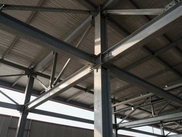 Low-angle shot of structural steel framework for a commercial hangar in Dammam, high contrast daylight, showing solid steel joints and bolts