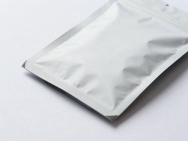 Macro photography of high-quality unmarked premium packaging on a clean slate surface, bright overcast daylight, cool tones, sharp focus, 35mm