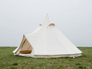 Wide architectural shot of a pristine white high-peak tent set up on a manicured green lawn, soft natural overcast daylight, clean lines
