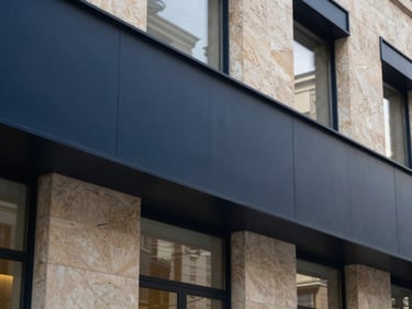 Architectural detail of a modern law office in Madrid, clean structured lines, soft natural light, deep navy and warm stone tones, 35mm