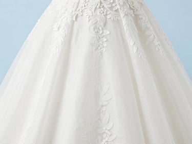 Detail of a white wedding dress fabric, delicate lace or embroidery, soft yet bright light, clean studio setting, 35mm lens.