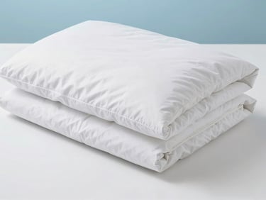 Neatly folded white duvet on a clean surface, soft light emphasizing freshness, clean white and blue tones, 35mm lens.