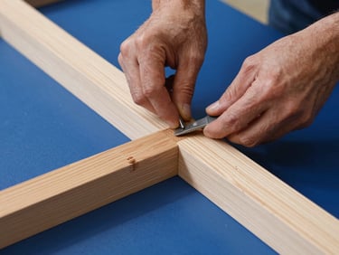 Detailed shot of a skilled craftsman working on a custom wood component, hands visible, focus on intricate joinery and tools.