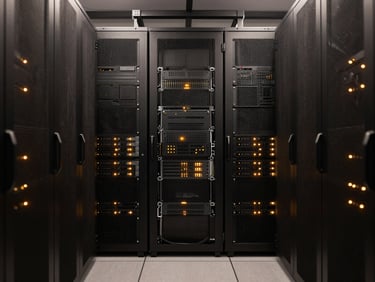 Symmetric high-contrast shot of a modern server room, dark racks with subtle amber indicator lights, clean architectural lines, 35mm