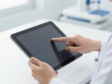 Hands of a medical professional pointing to a clear diagnostic image on a modern tablet screen, clean clinical setting, bright lighting, blue and white tones.