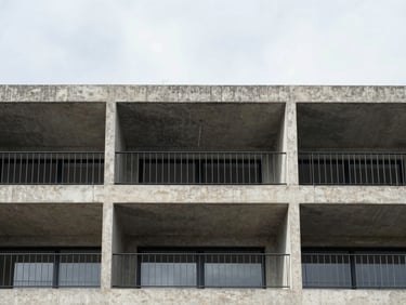 Exterior view of a brutalist concrete penthouse balcony in Polanco, steel railings, minimal design, overcast sky, architectural detail