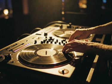 Sleek, wire-free DJ booth in a low-light historic venue, warm golden uplighting, close-up of hands on vinyl controllers, deep shadows, 35mm film grain.