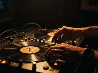 Low-light atmospheric close-up of hands on a vinyl controller, warm golden uplighting, deep shadows, 35mm film grain