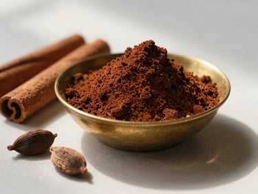 Macro shot of dark, coarse spice powder inside an antique brass bowl, raw cinnamon sticks and cardamom pods scattered nearby, soft shadows, 35mm film