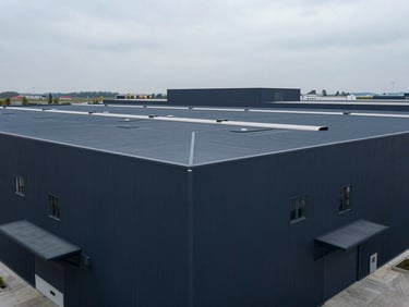 High-angle geometric composition of a clean, modern logistics hub, cool overcast daylight, desaturated navy tones, sharp focus, 35mm.