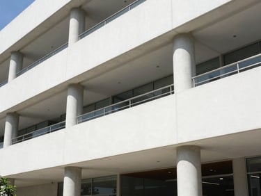 Crisp architectural photography of a modern corporate office interior in Mexico, bright natural daylight, clean geometric lines, 35mm