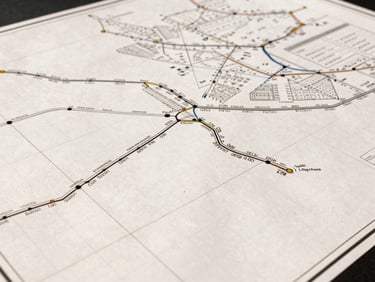 Overhead shot of a logistics planning map with geometric grid lines and route data, bright industrial lighting, sharp focus, industrial commercial photography, high-contrast warm tones.