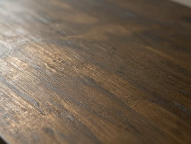 Macro shot of hand-applied bronze metallic coating, subtle oxidation patterns, shifting light reflections