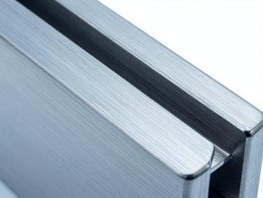 Macro detail of a custom stainless steel architectural fitting, clean brushed texture, professional metallic finish