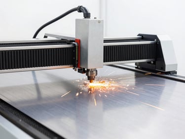 A modern laser cutting machine processing a sheet of stainless steel, crisp orange sparks flying, bright high-key lighting