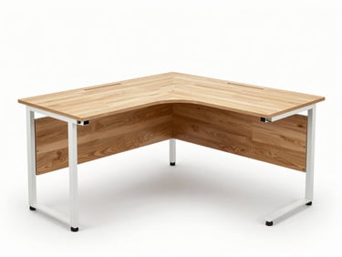 Studio photograph of a light oak laminate L-shaped corner desk with cable management holes and white metal frame, straight-on angle, white background, bright studio strobe lighting, no people