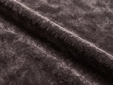 Close-up of deep matte cotton velvet in a warm charcoal tone, showing the dense pile and subtle light absorption.