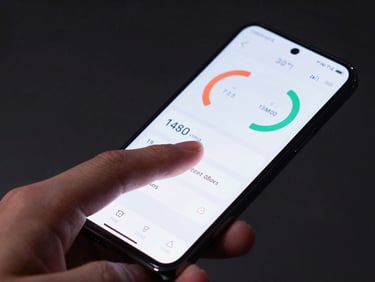 Close-up of a hand navigating a clean utility app dashboard on an Android phone, cool flat studio light, dark background, performance metrics visible on screen