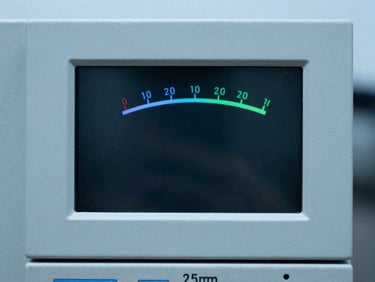 Close-up of a digital protection relay display active with voltage readings, cool slate tones, sharp focus, 35mm