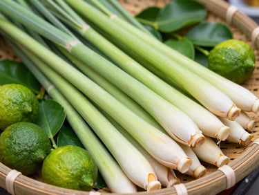 Macro detail shot of crisp green lemongrass stalks and fresh kaffir lime leaves in a bamboo basket, bright natural light