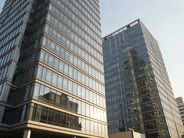 Wide-angle architectural shot of modern glass office towers in Kharadi under bright afternoon sunlight, high-contrast architectural detail, warm editorial photography, 35mm lens