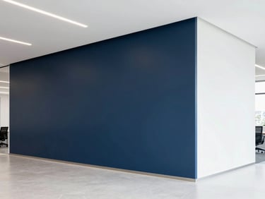 Bright modern office interior with a freshly painted accent wall in deep navy, clean minimalist architecture, natural light