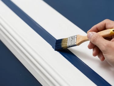 Macro detail of a professional painter using a brush to create a sharp paint line against clean white trim, bright daylight, navy blue accents