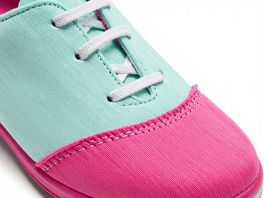 Macro photograph of colorful shoe stitching and vibrant retro fabric, high contrast studio lighting, quirky retro product photography