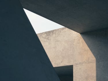 Abstract architectural lines of a concrete structure, clean geometric shadows, soft diffused daylight, minimalist clinical editorial style