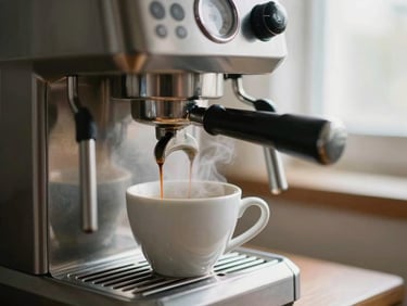 A compact stainless steel espresso machine brewing coffee into a white ceramic cup, steam rising softly, warm natural lighting, shallow depth of field