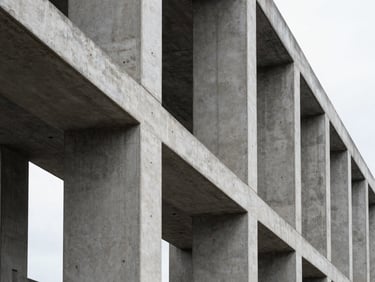 High-contrast architectural perspective of structural concrete and steel columns under overcast daylight, sharp clean lines, minimal composition.